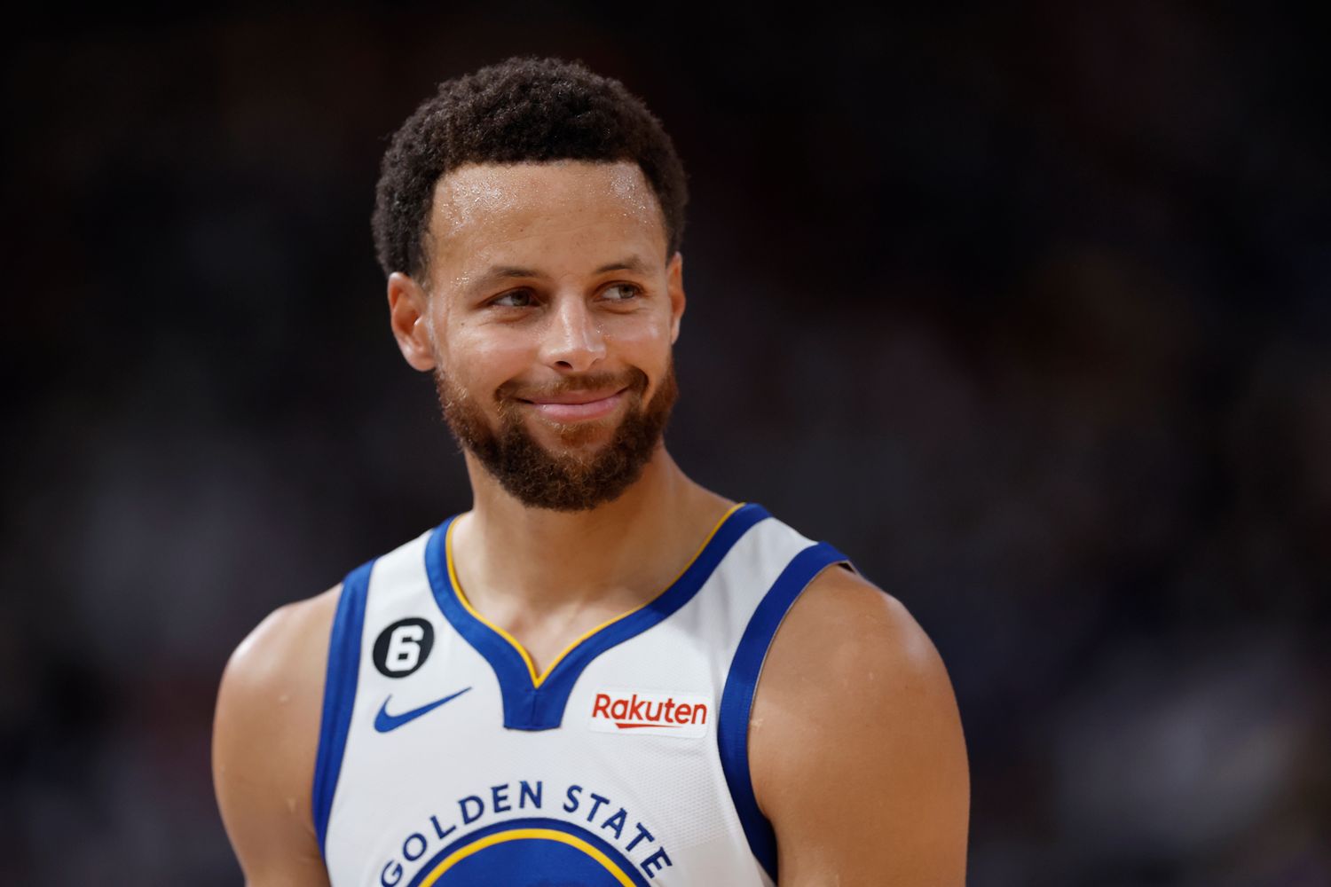 Stephen Curry smiles after a play.